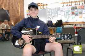 Finn Baxter played guitar for his group.