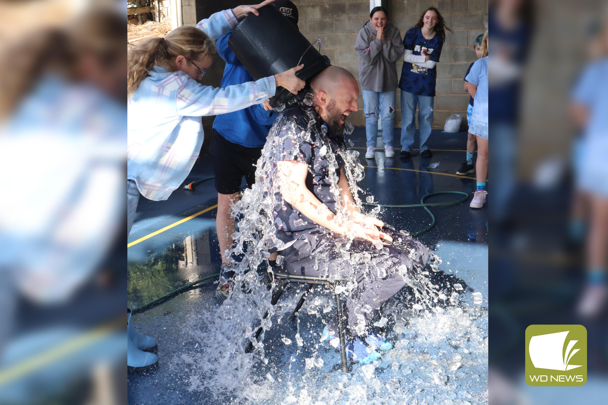 Extra chilly: Teachers were soaked with iced water in the name of charity last Friday.