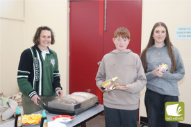 School nurse Mel Benson manned the pancake stand while students Cale Roach and Phoebe Harris enjoyed the meal.