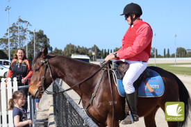 All smiles: Kids had the opportunity to meet horses between races.