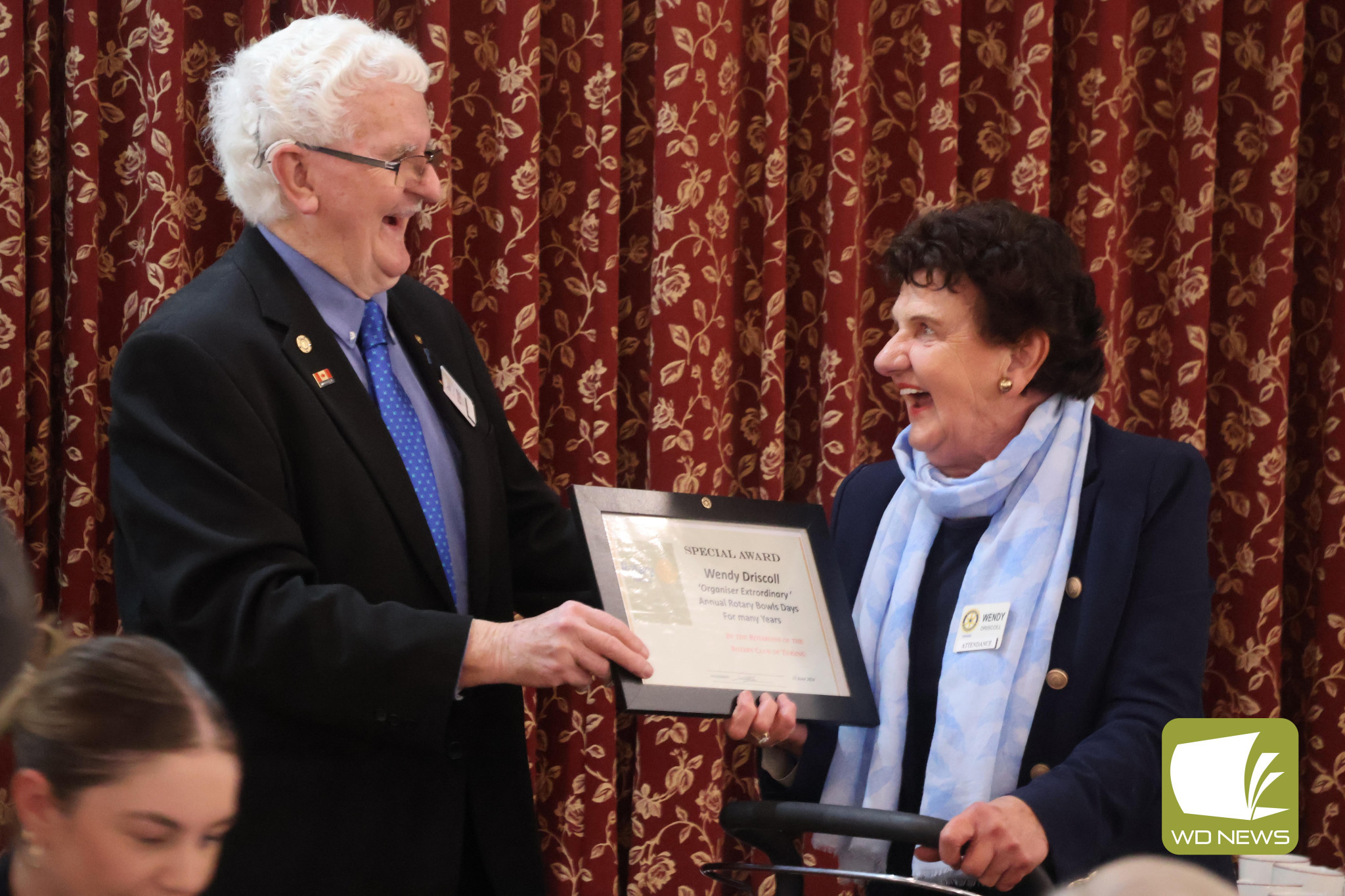 Dedication: Bob McIntosh surprised Wendy Driscoll with a special award acknowledging her long-time involvement with the club’s Rotary Bowls Day. The recognition, which Geoff Elford also received, followed the difficult decision to cease the long-running event.