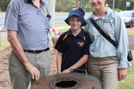 Timboon Lions Club president Owen Wallace with Corangamite Shire mayor Kate Makin and her son Leo, who took a peek into the capsule.