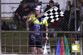 Max Leersen waving the chequered flag.