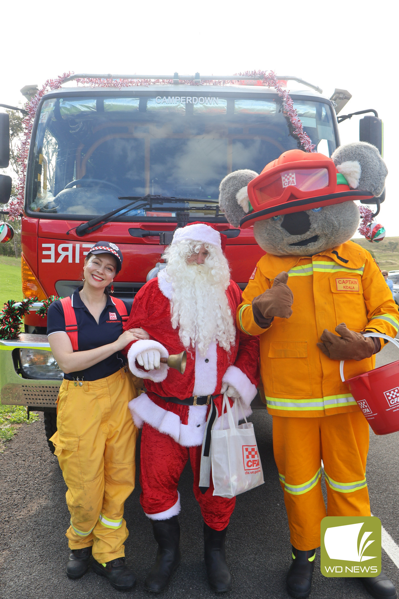 Festive tour: Camperdown CFA’s Sarah Blair, Santa Claus and Captain Koala took a tour around Camperdown in a decorated fire engine, delivering lollies and small surprises at every stop.