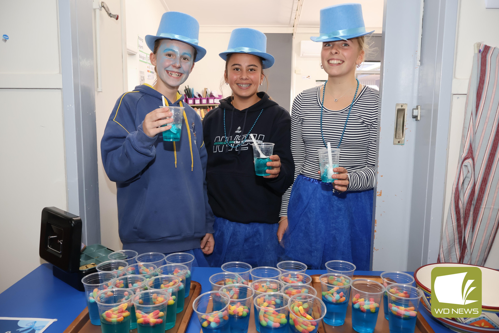 United: Isabella Reichman, Ivy Wardlaw and Ashlee Killen helped selling blue jelly cups to raise funds for Dolly’s Dream.