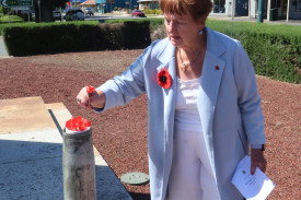 Where poppies bloom: Residents were invited to lay poppies at the memorial, with many also choosing to wear the poppy on their clothing for the day.