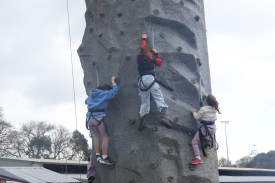 Despite less than ideal weather, many children scrambled to the top of the rock-climbing wall.