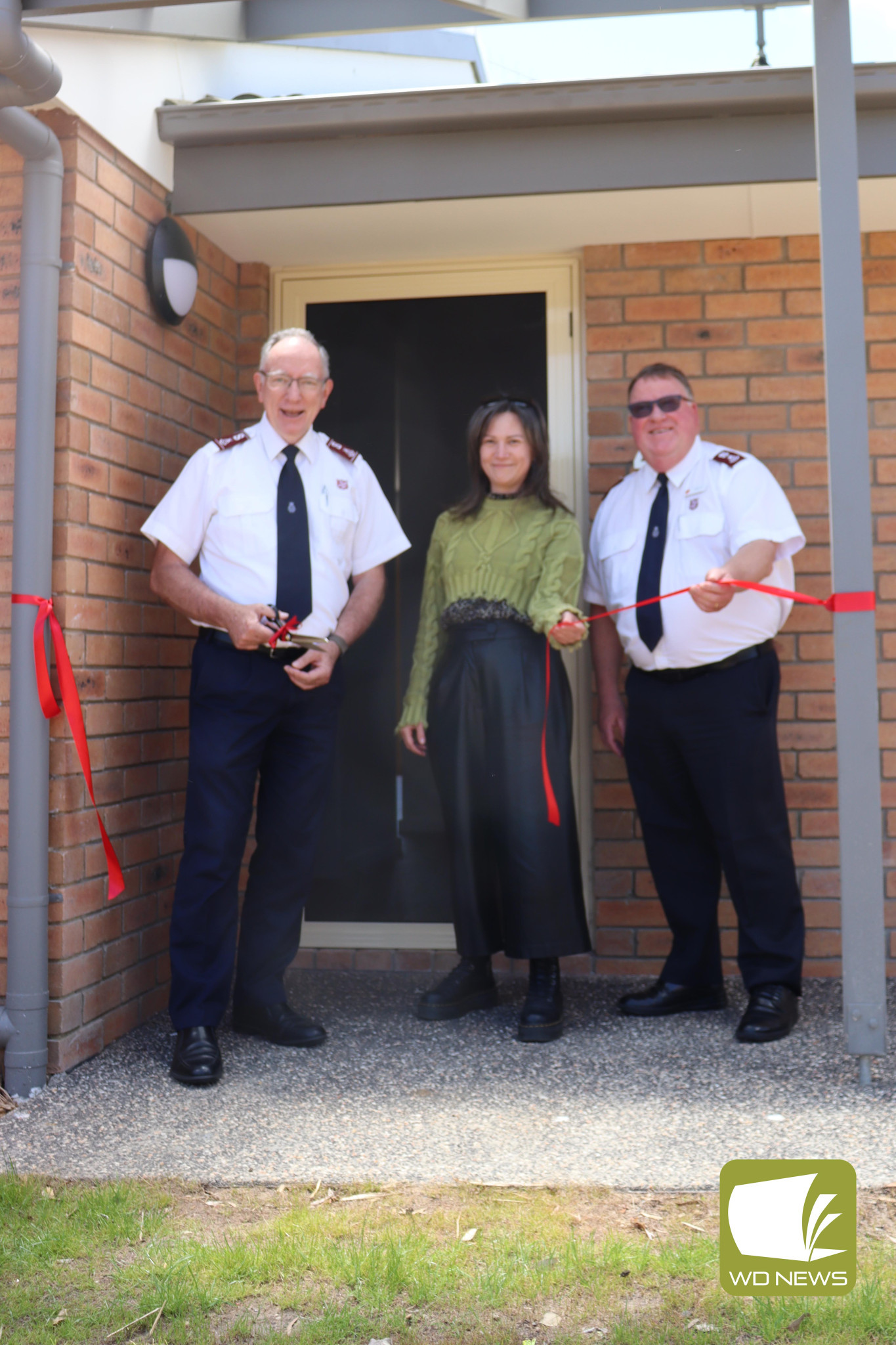 Project complete: Salvation Army representatives Major Mark Kop, Irena Baric and Colonel Kelvin Merrett cut the ribbon at the unveiling of the Tandarook House project, with all six units rented out.