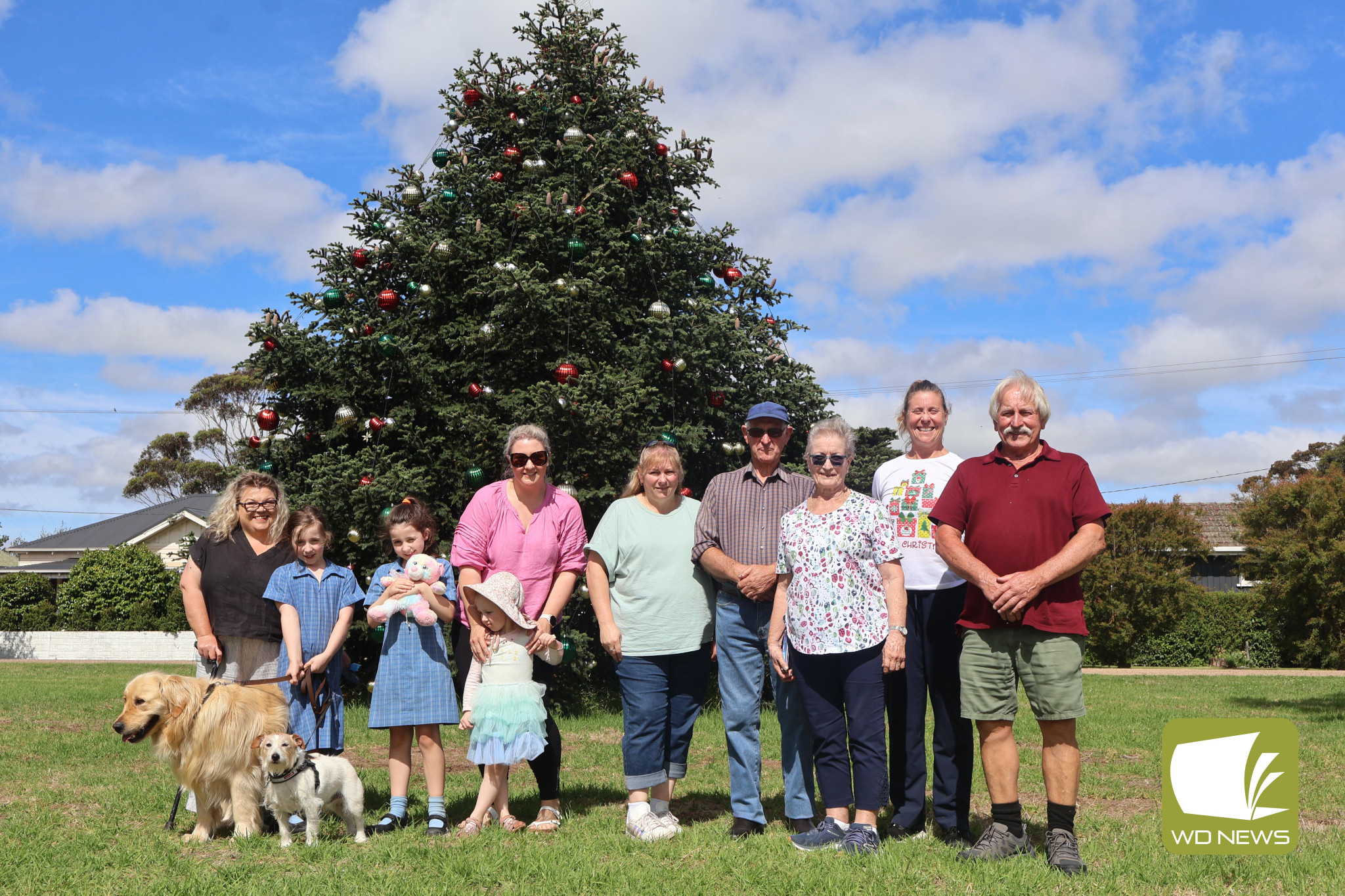 Happy holidays: Members of the Porter family met with the community members who have been hard at work to transform the tree in to a festive delight.