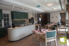 The communal dining space includes a commercial kitchen behind the serving area to provide greater meal choice.