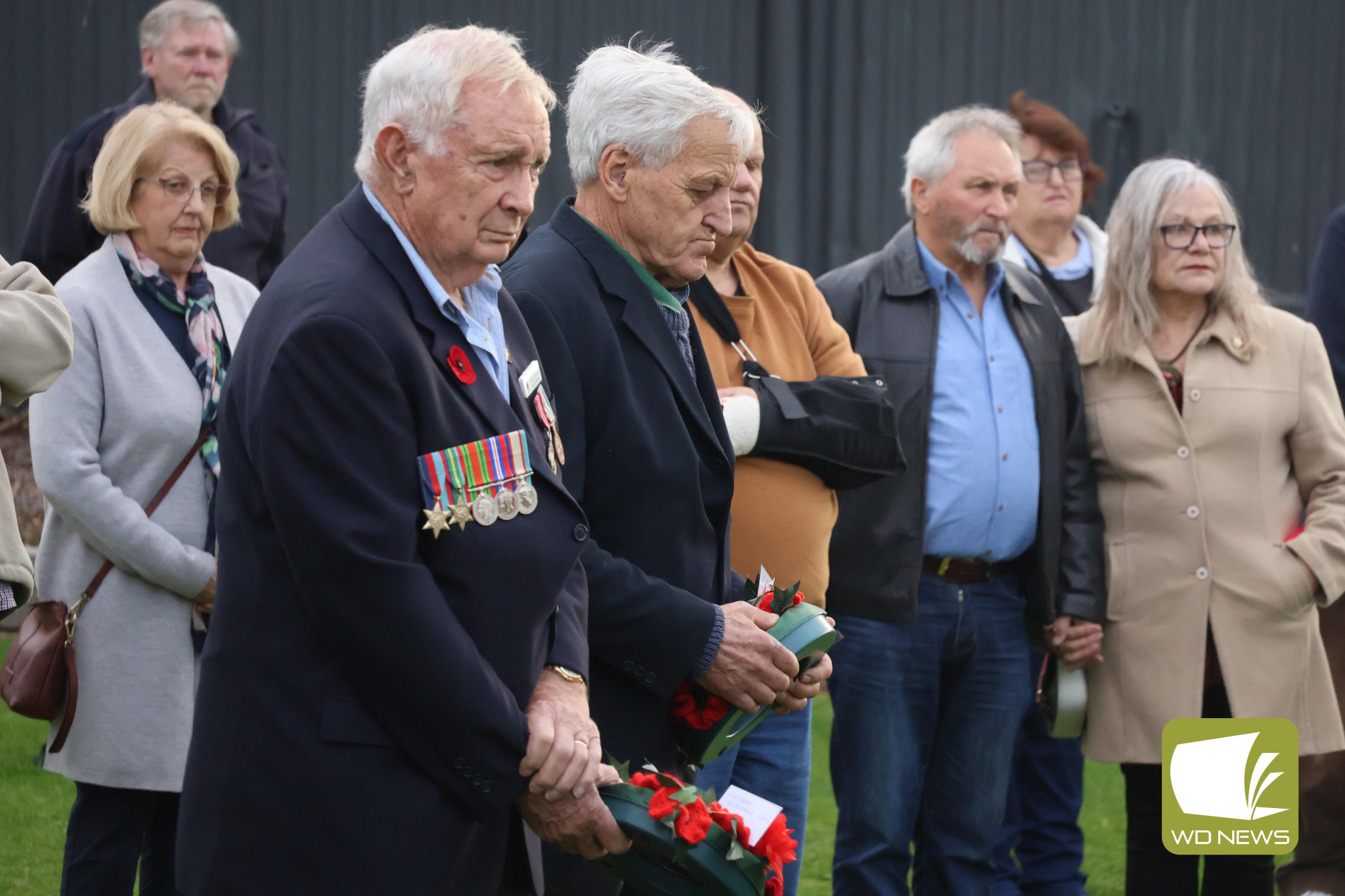 Solemn: A crowd of around 30 gathered to pay its respects.