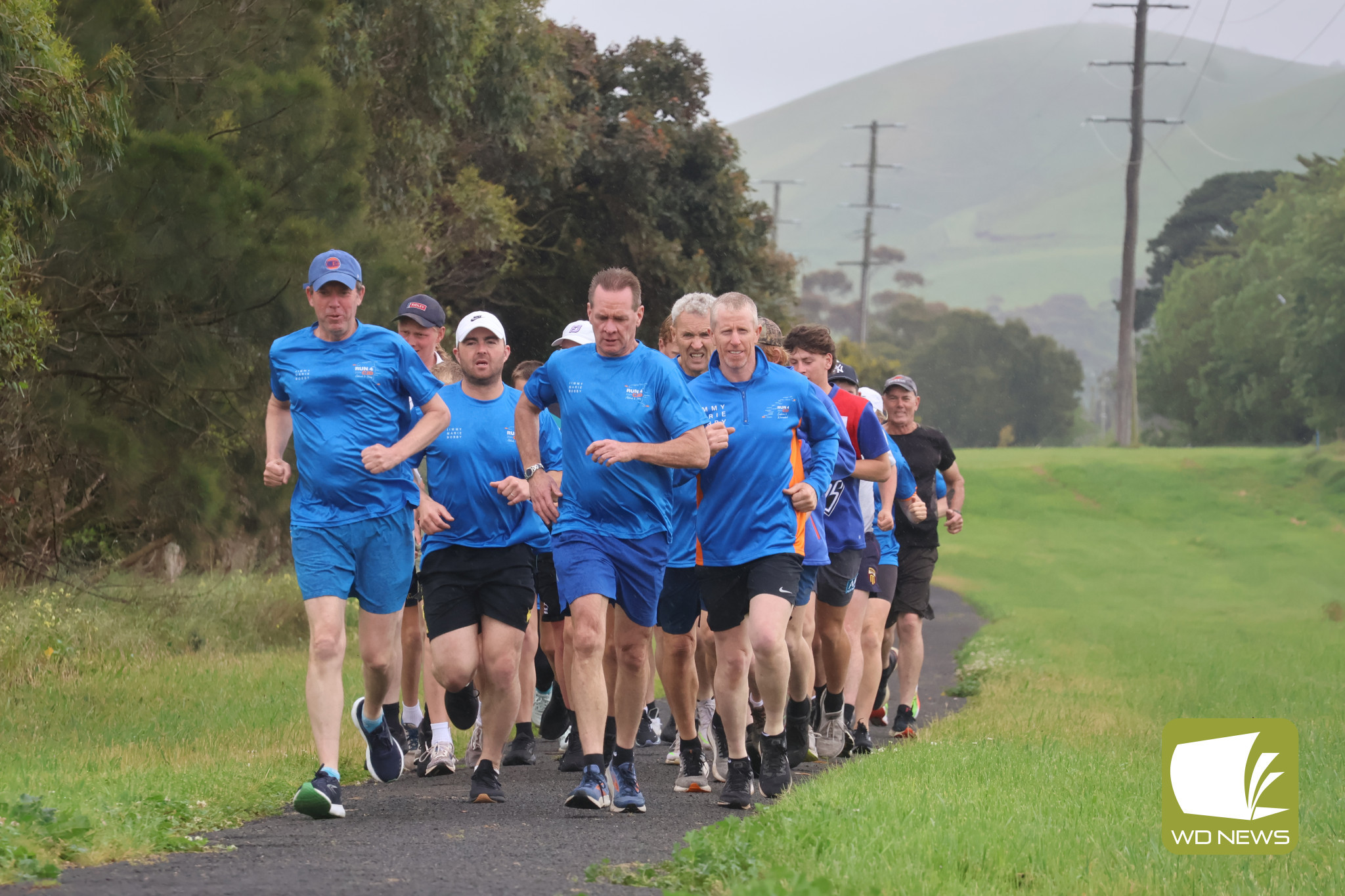 Home stretch: The runners did not let the rain deter them as they began the final 5.92 kilometre run back to Terang.