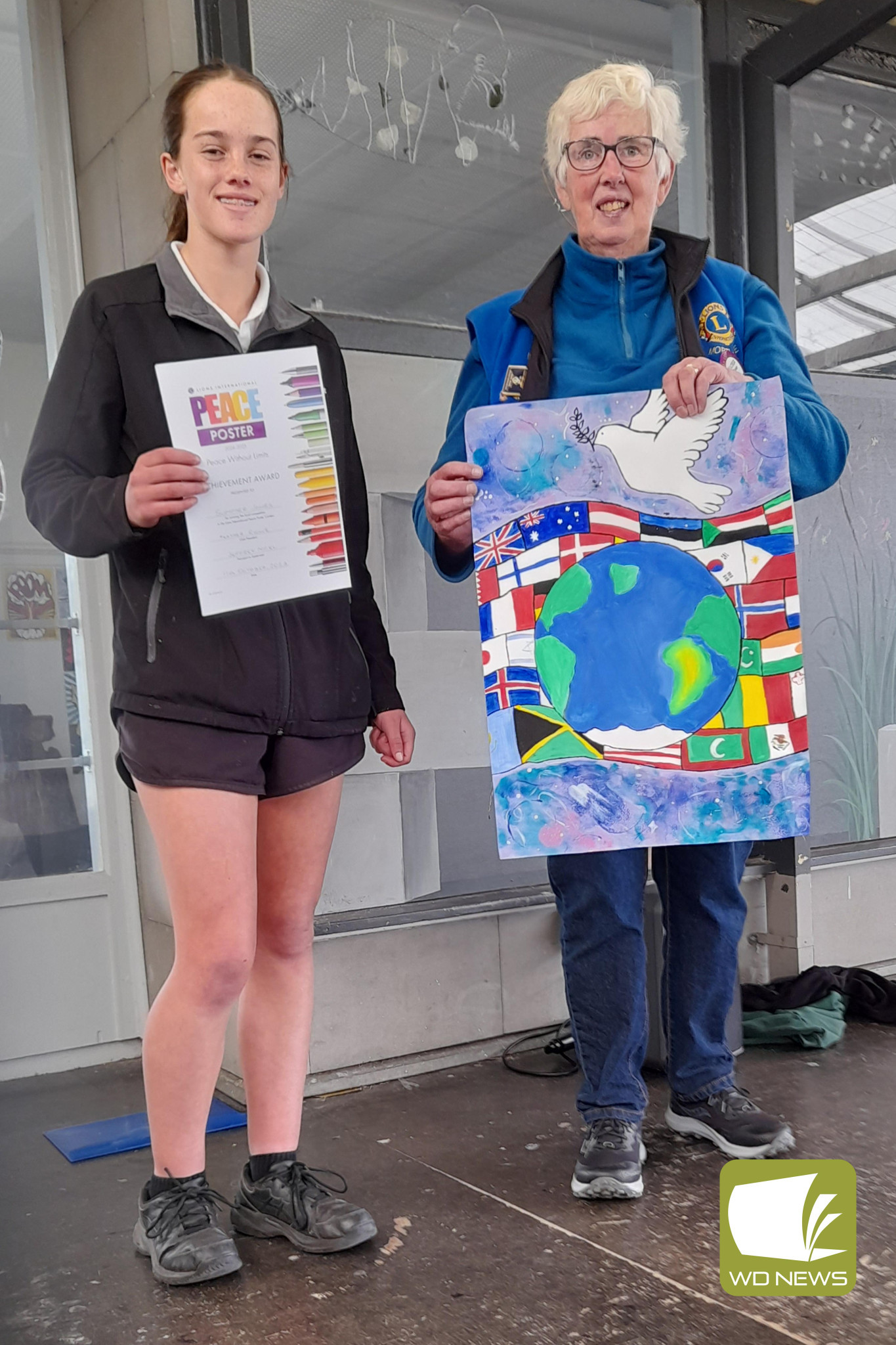 Unity: Mortlake College student Summer Jones, pictured with Mortlake Lions Club president Heather Rowe, was named a winner in this year’s peace poster competition.