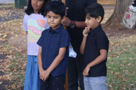 Some residents led the crowd with the processional cross, including a group of four children who assisted each other in carrying the cross.