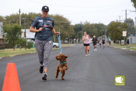 Barking mad: Sometimes you just need the support of a furry friend to help you across the line.