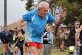 Still going: Stewart McArthur, 86, received an ovation while crossing the line.