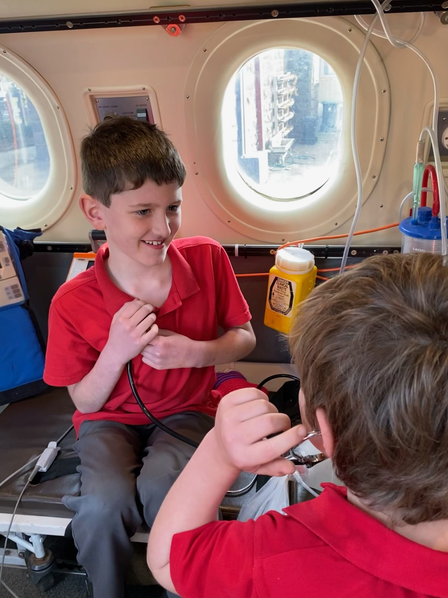 Taking flight: Callum Baird had his heart rate checked by Harrison Gurry about the RFDS simulator.