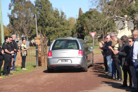 Members of the Woorndoo-Mortlake Football Netball club formed a guard of honour to farewell Kath Grant, offering a final round of applause after she had supported the club for more than six decades.