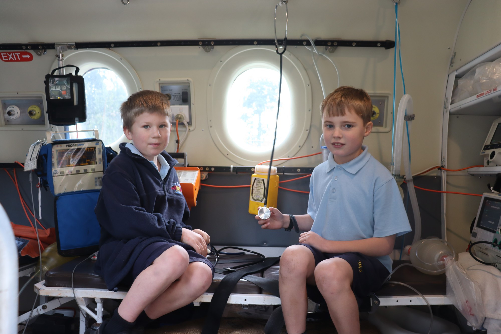 Cool visit: Timboon P-12 School students Isaac Brumby and Cameron Loring inspect the flight simulator.