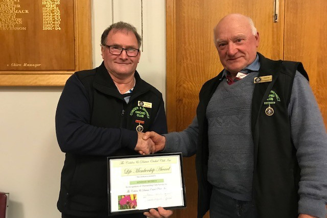 Cobden Orchid Club’s (left) Lindsay Rethus was awarded a Life Membership from David Staggard at the recent meeting.