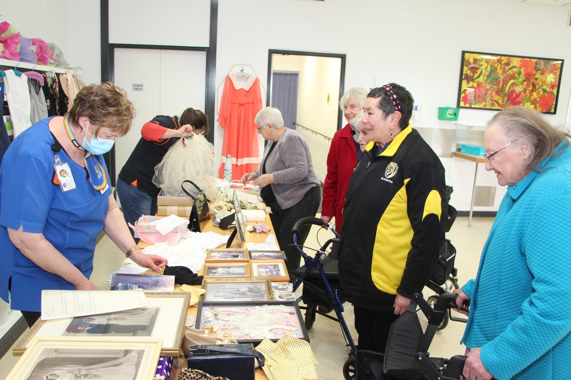 Sharing memories: Terang and Mortlake Health Service social support co-ordinator Wendy Errey shares the story behind wedding memorabilia with social support clients.