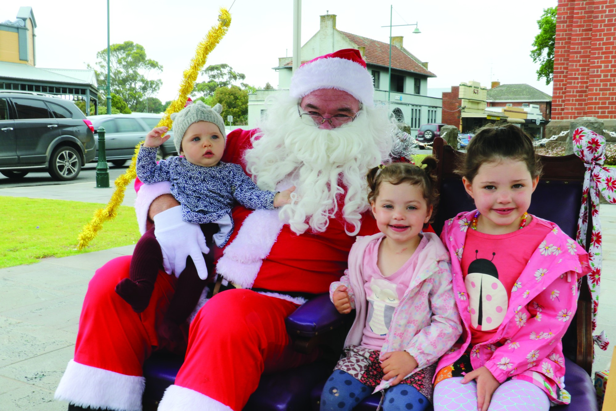 Frankie, Tessa and Amber Narik catch up with Santa in the avenue as part of the Camperdown Christmas Festival over the weekend.