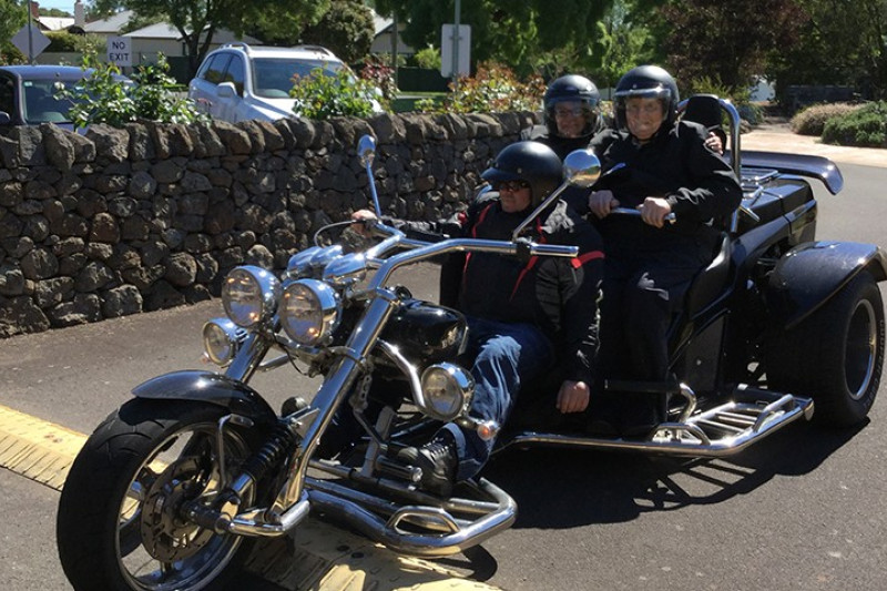 Sunnyside House chief executive officer Claire Schmierer and resident Bill Baker don their helmets for a Harley trike ride to Camperdown’s twin lakes.