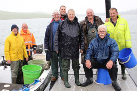 Camperdown Angling Club members and supporters braved wintery conditions to release 80,000 salmon and trout fingerlings into Lake Bullen Merri.