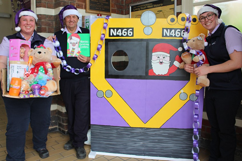 V/Line Camperdown staff (from left) Melissa Lukin, Wes Bramwell and Mariah Smyth have pooled their creative talents to bring the festive cheer to the local station and are inviting youngsters down to grab a snap with a Santa photo board and test their colouring-in skills to win one of three prize packs.