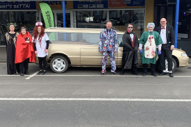 Retailers stand in front of a gold hearse which was parked in the main street to add to this year’s atmosphere.