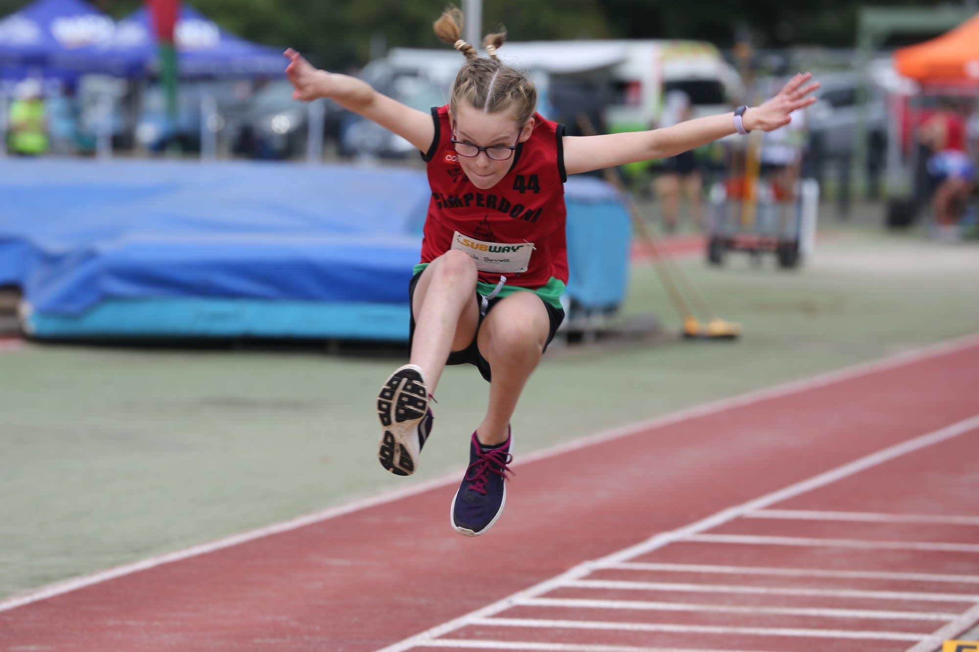Lila Bennett flies through the air on her way to a personal best effort in triple jump where she placed third.