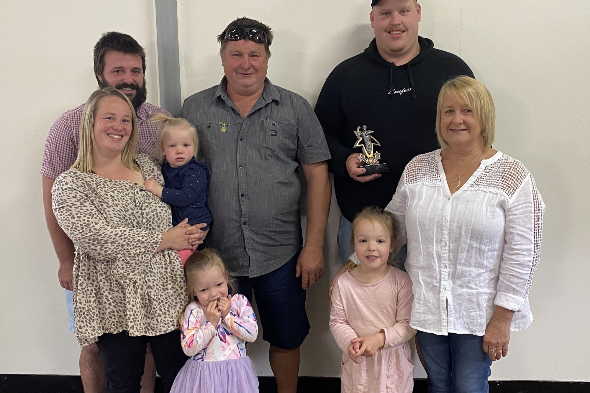 Tom Henry (back right) accepted the Paul Fitzgerald Memorial Trophy from members of the Fitzgerald family.