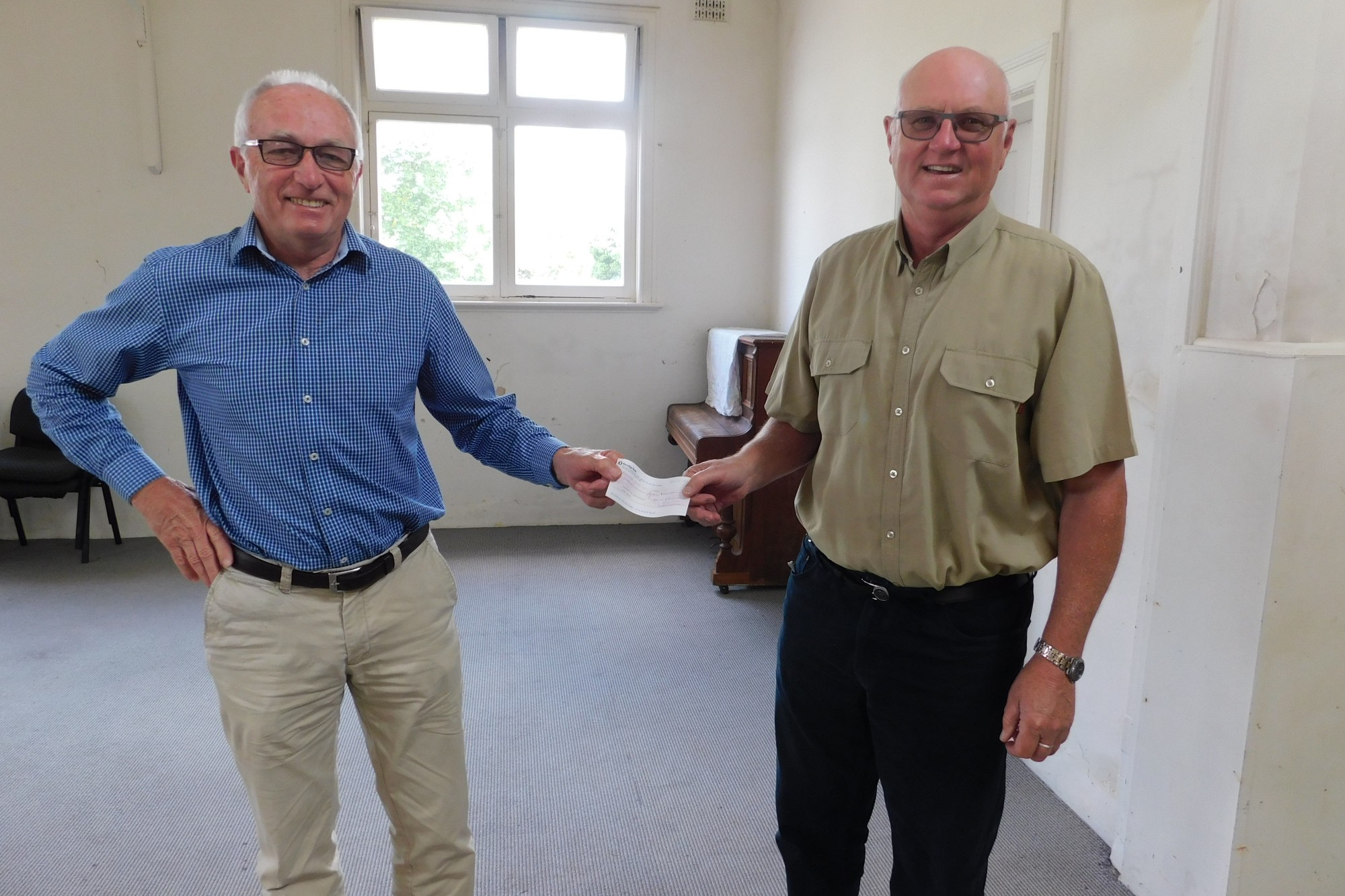 Community spirit: Bernie Sinnott (right) presents Sunnyside House Inc board chairman Philip Downie with a cheque for $500,000 which was a bequest from Graeme Bant.