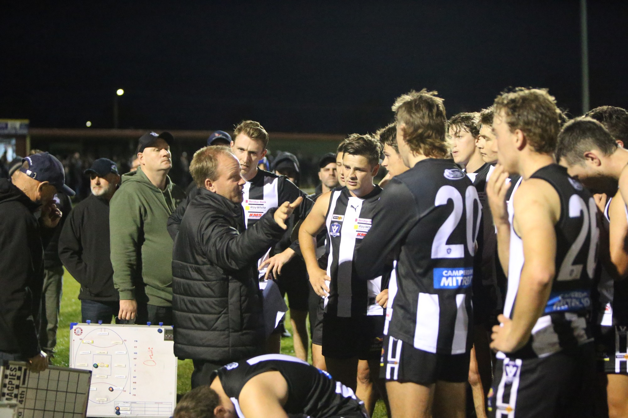 Strong start: Camperdown coach Neville Swayn addresses his players during the Magpies 35 point win against Cobden last Saturday night.