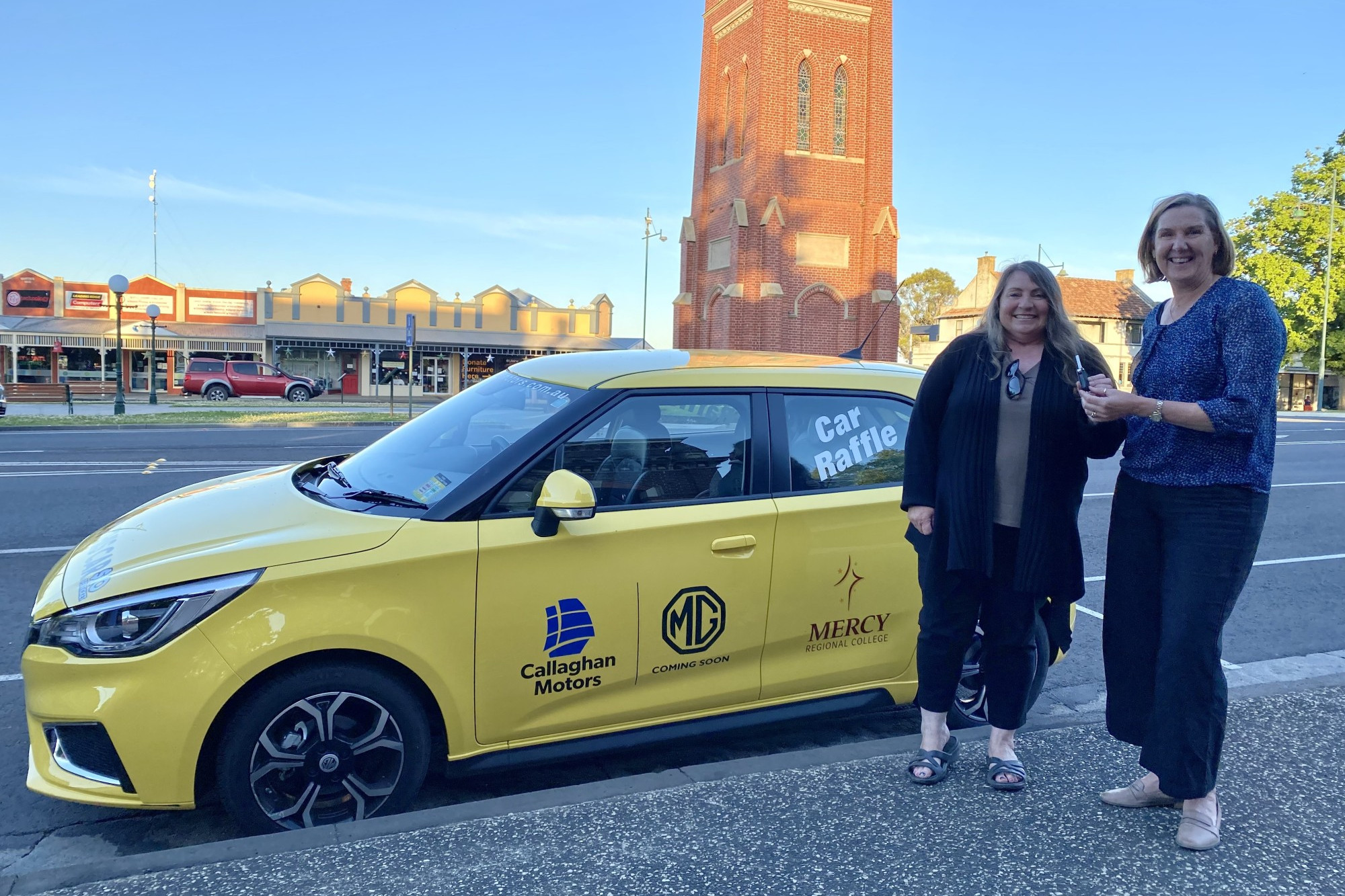 Congratulations: Diane Kenna accepting the car keys from MRC Principal Sharon Gillett.