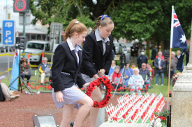 Camperdown College junior school captains Kiera Johnston and Lila Horspole lay a wreath at the service. 