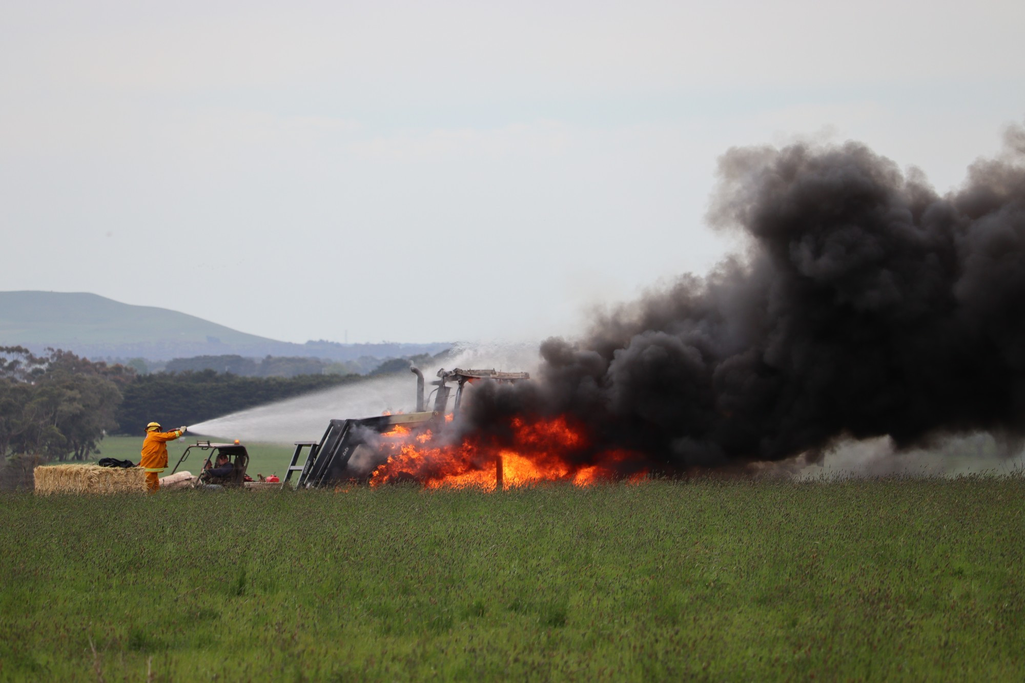 Fire: CFA volunteers work to extinguish a blaze which destroyed a tractor at a Boorcan property on Wednesday afternoon.