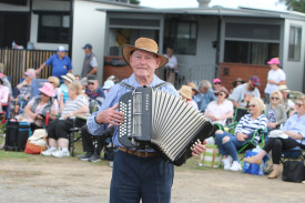 Musician Joe Rundel entertains the crowd on the piano accordian. 