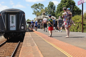 Locals and visitors line the platform to get a look at the train. 