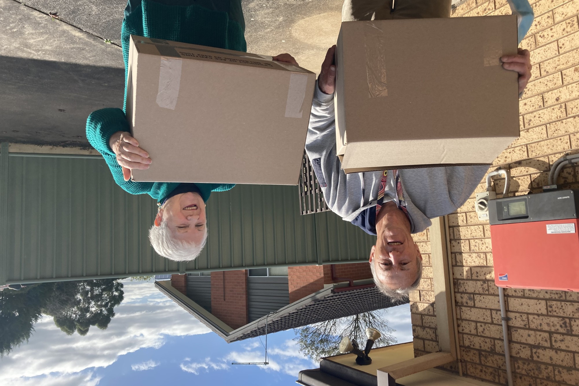 Knitting donations: Chris from Colac Area Health accepts a donation from Kay on behalf of a Camperdown Community House knitting group.