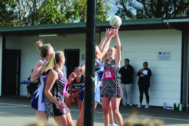 Mary Place shoots for goal while Krystal Baker prepares for the rebound. 