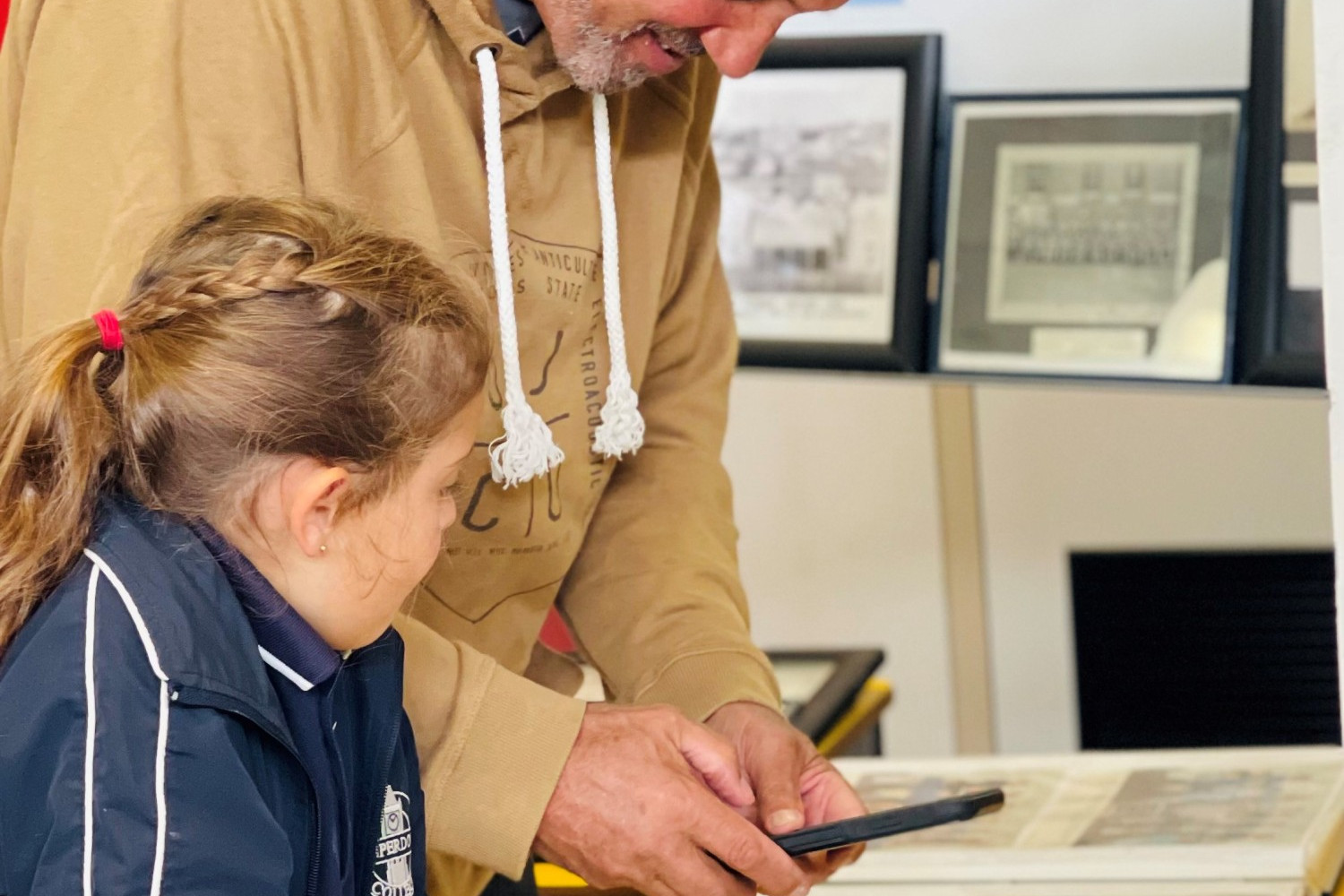 Emilia Narik with pop Richard perusing old school photos.