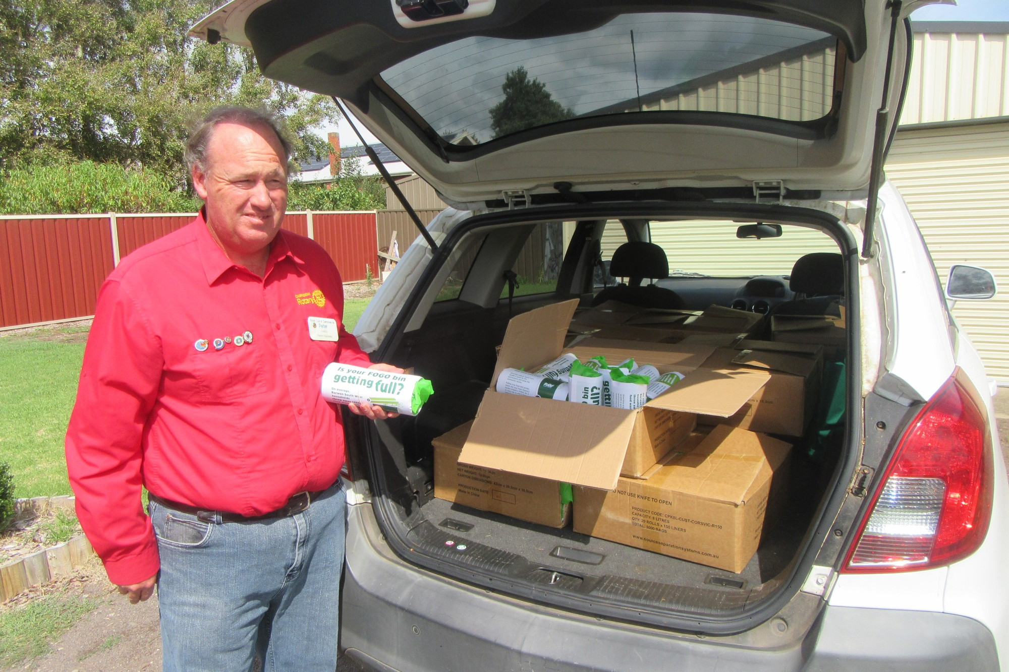 Community service: Rotary Club of Camperdown president Peter James helps to deliver compostable bin caddy liners around Camperdown.