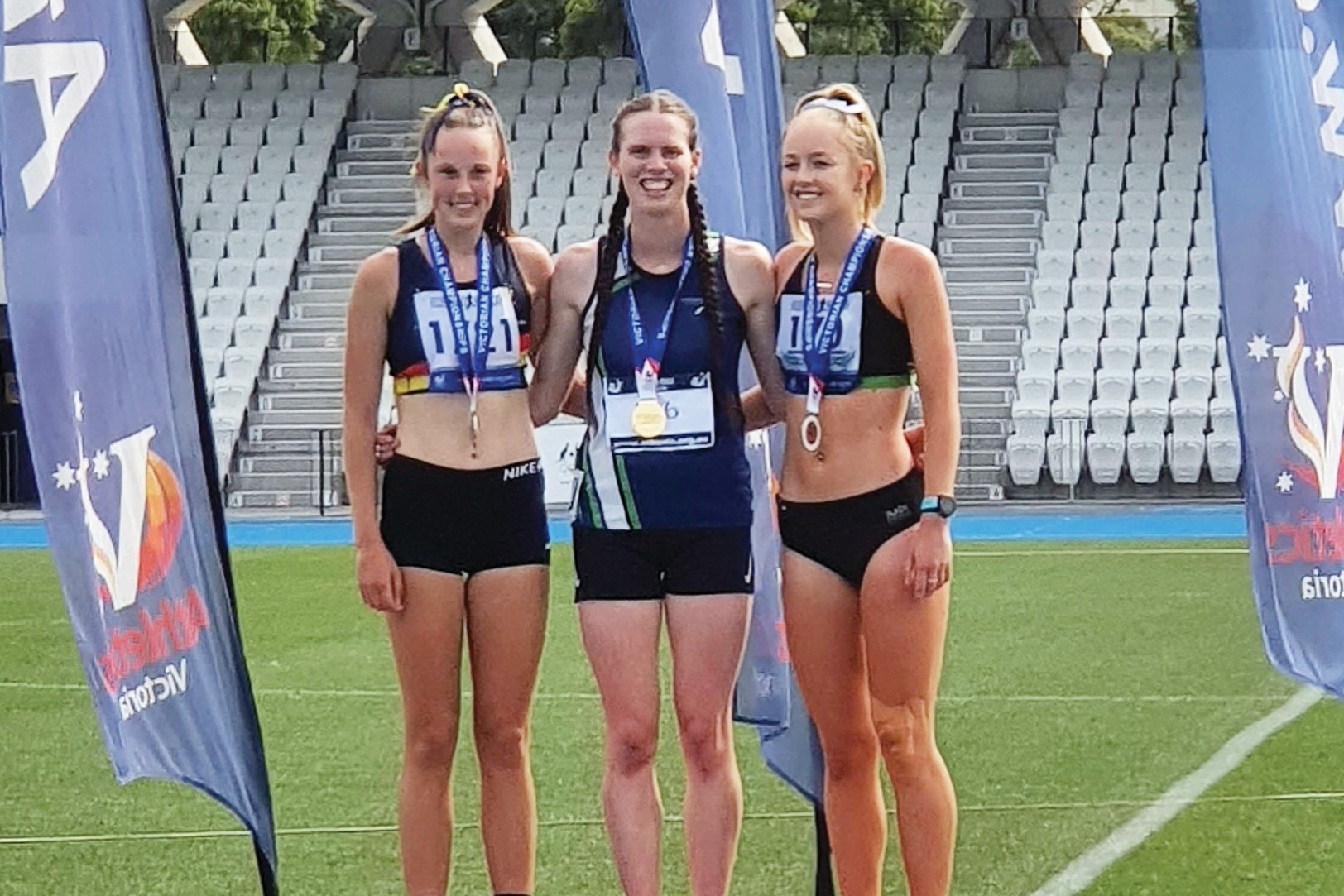 Left: Emily Morden receives her gold medal for winning the 1500m at the under 20s Victorian Championships.