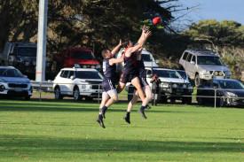 Lochlan Isbister takes on two Eagles in a marking contest. 