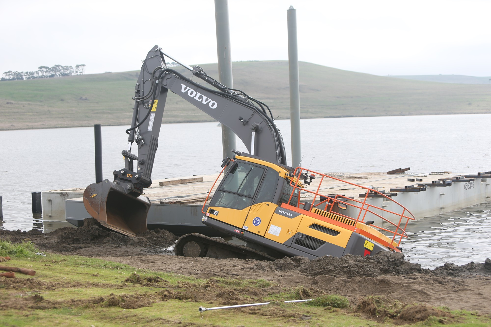 Stuck: Under-water works at the boat ramp were temporarily halted after this excavator became bogged last week.