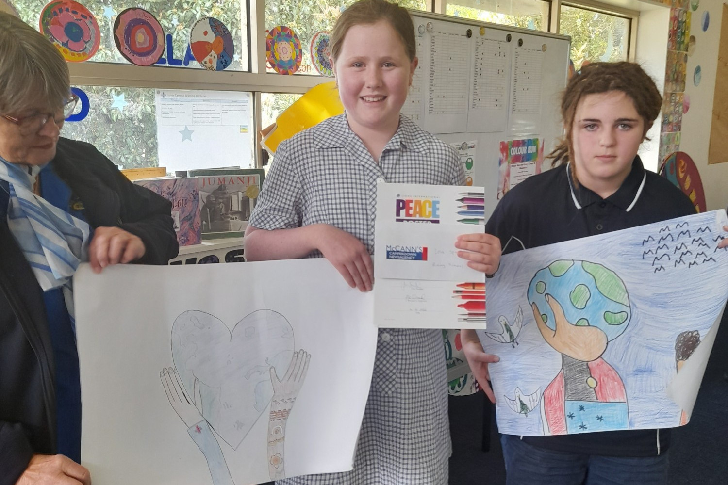 Camperdown Lions Club’s Trish Taylor with Camperdown College winners Isla Spokes and Madilyn Neilson.