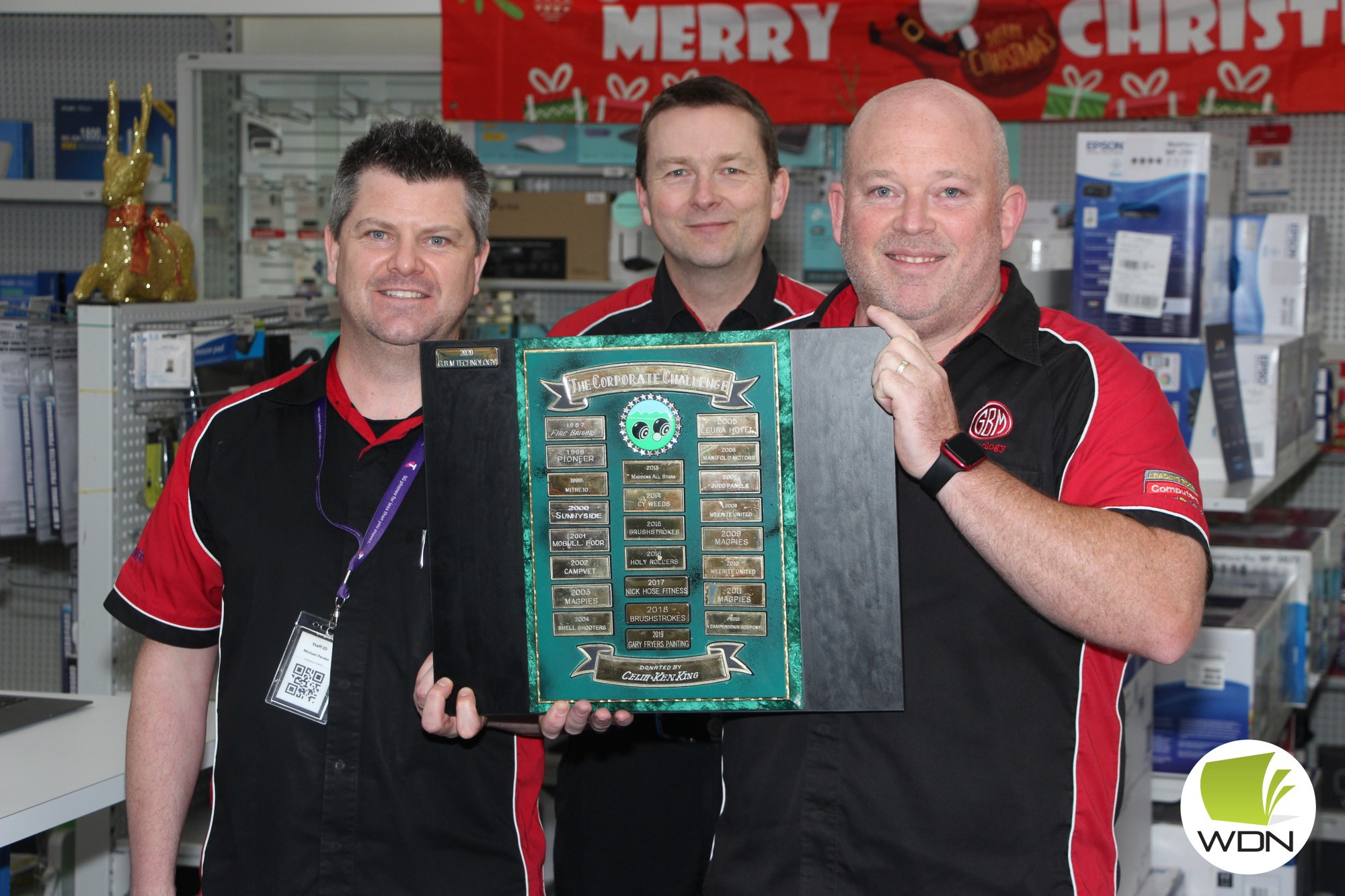 Reigning champions: Michael Pender, Randall Hose and Glen Bernoth with the winners’ trophy from the last contested corporate bowls championship.