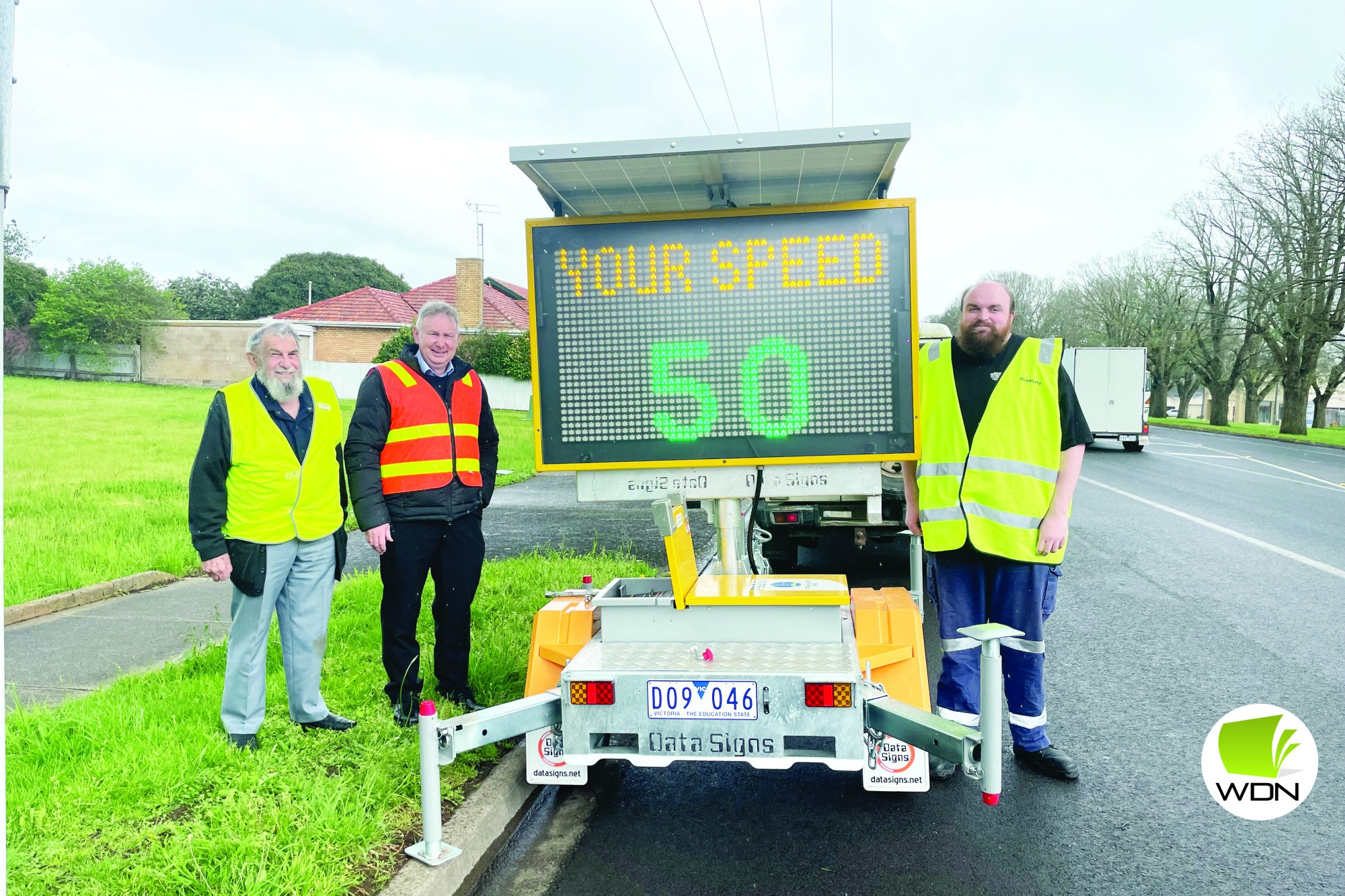 Grant success: Roadsafe Otways Cliff McAliece (left), Corangamite Shire’s John Kelly and Roadsafe Otways Daniel Duke install a new variable message board at the entrance to Camperdown on Friday.