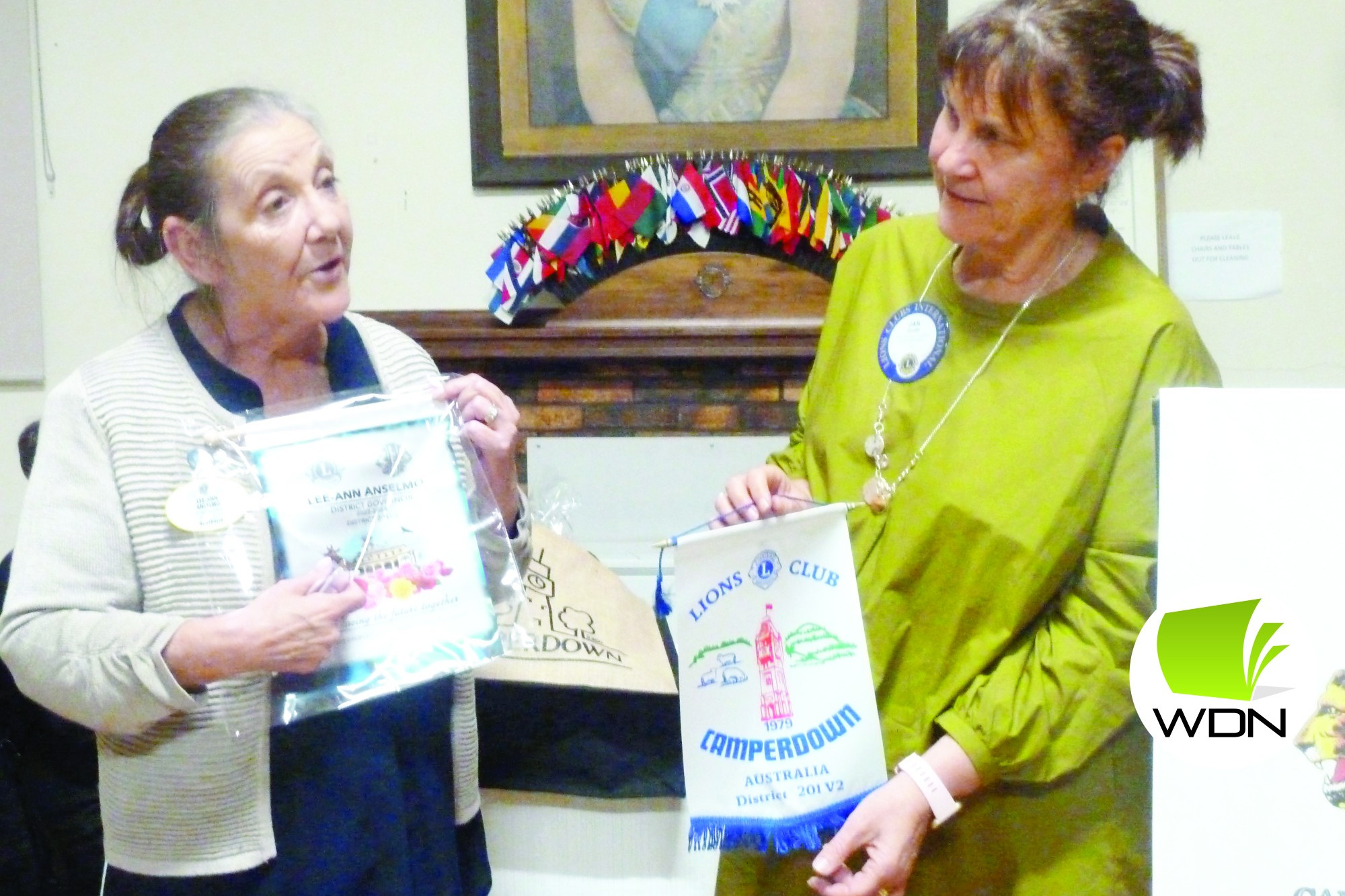 Lions district governor Lee-Ann Anselmo presents her bannerette to Camperdown club president Jan Smith.